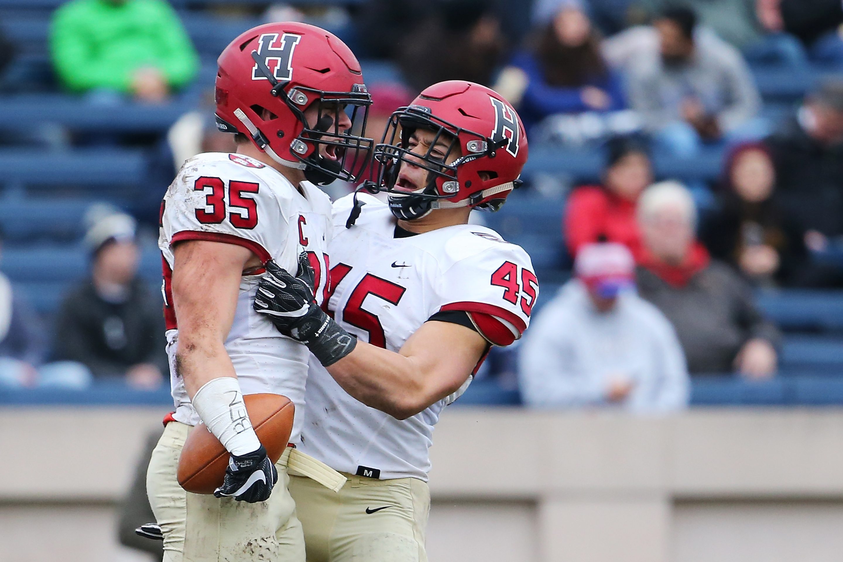 Photo of two Harvard football teammates at the Harvard v. Yale game