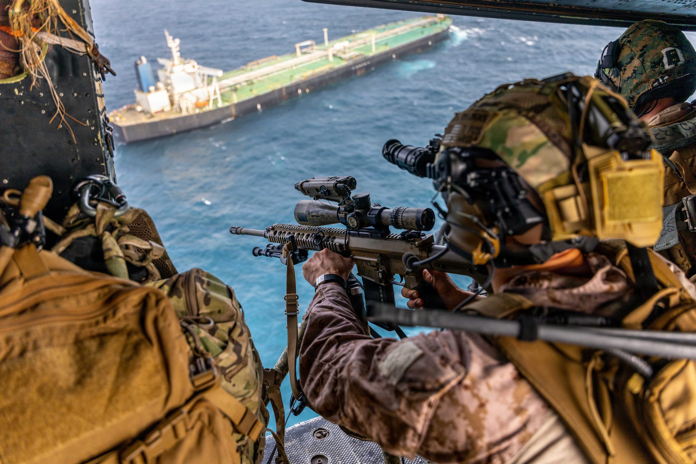 A U.S. Marine with Battalion Landing Team 3/5, 11th Marine Expeditionary Unit, sights in on a M110 semi-automatic sniper system during a maritime interception operation in the U.S. Central Command area of responsibility, July 16, 2026.