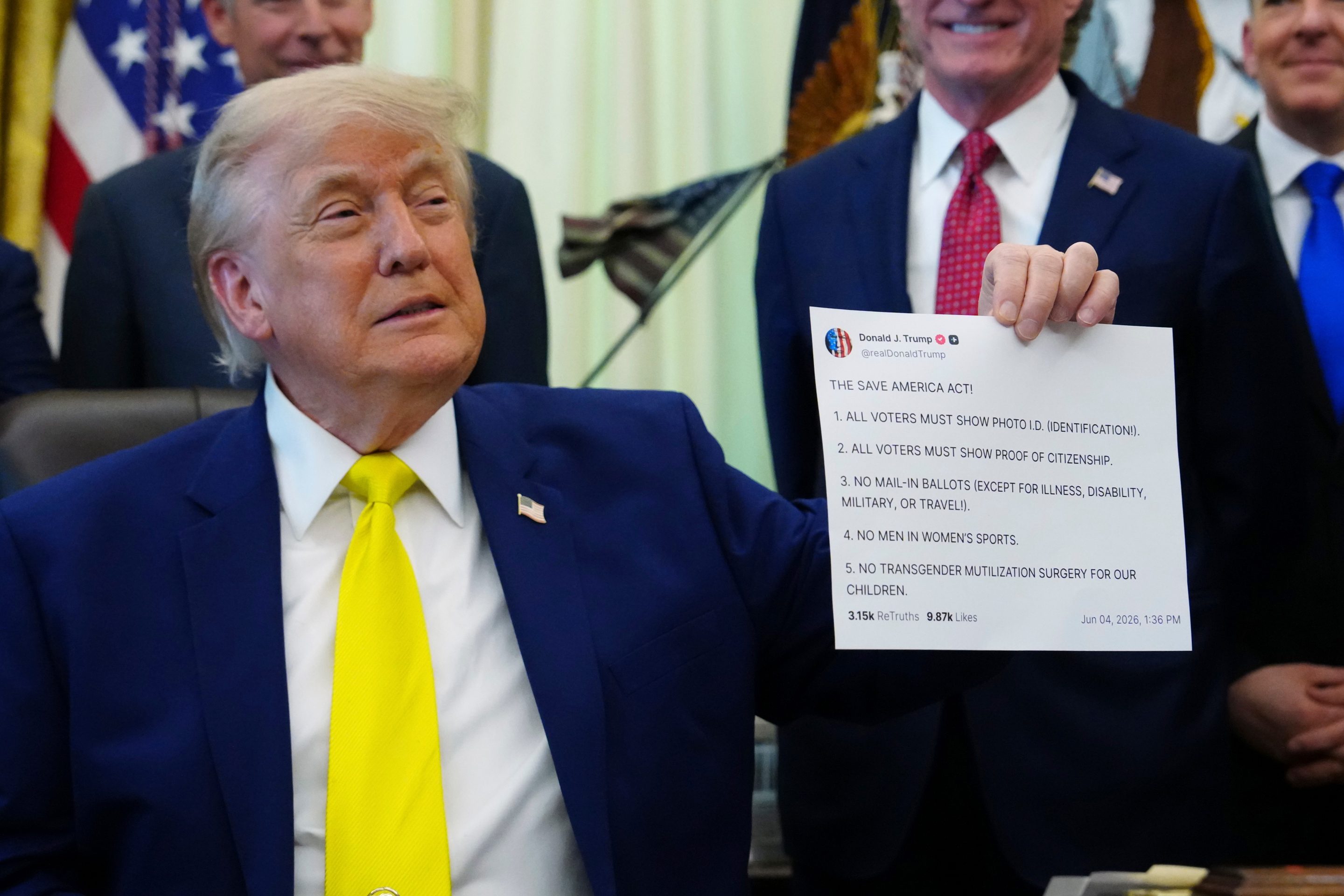 President Donald Trump holds up an image taken from his Truth Social account at an event about coal, Thursday, June 4, 2026, in the Oval Office of the White House.