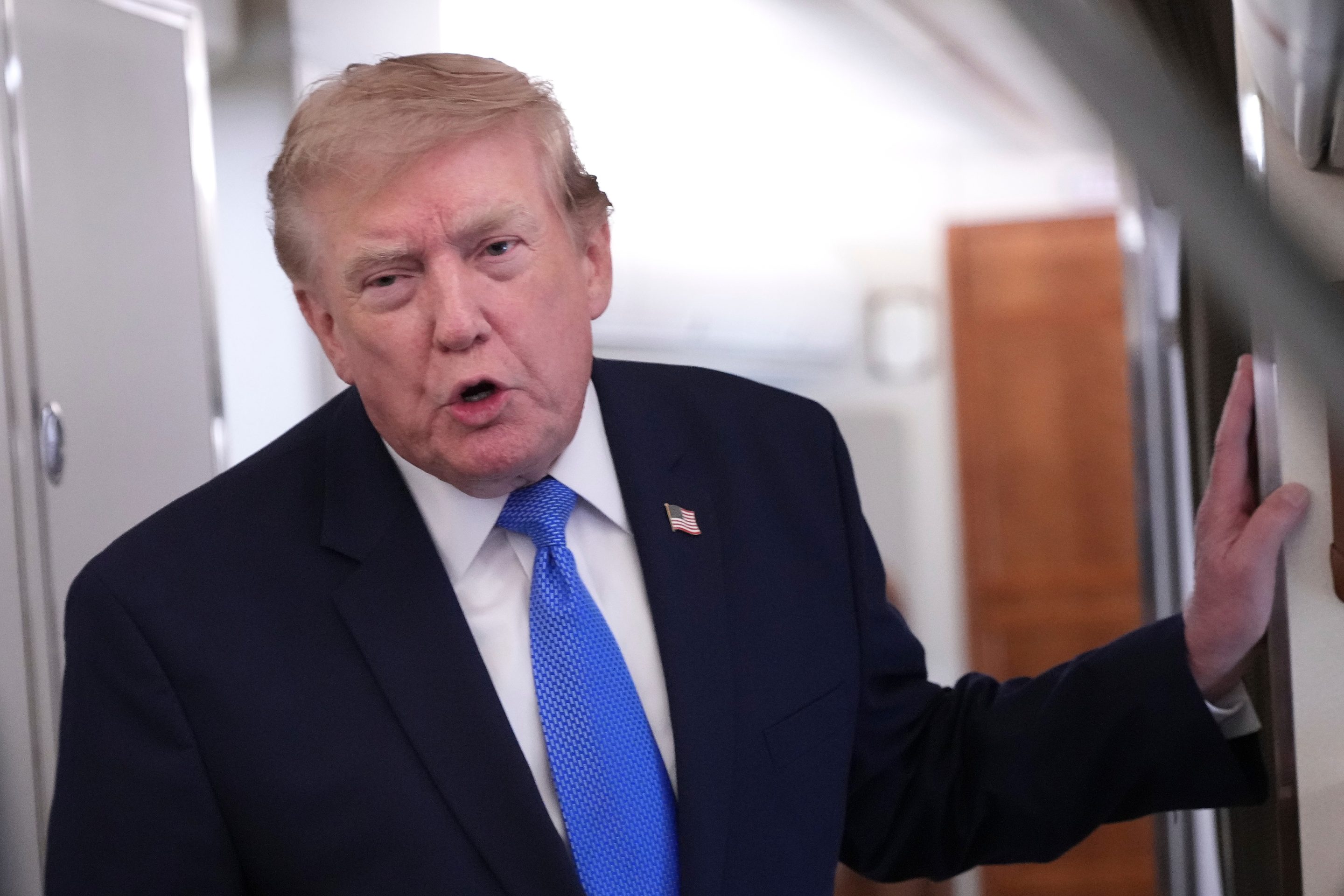 President Donald Trump speaks to reporters onboard Air Force One while returning to the White House, Sunday, Aug. 2, 2026.