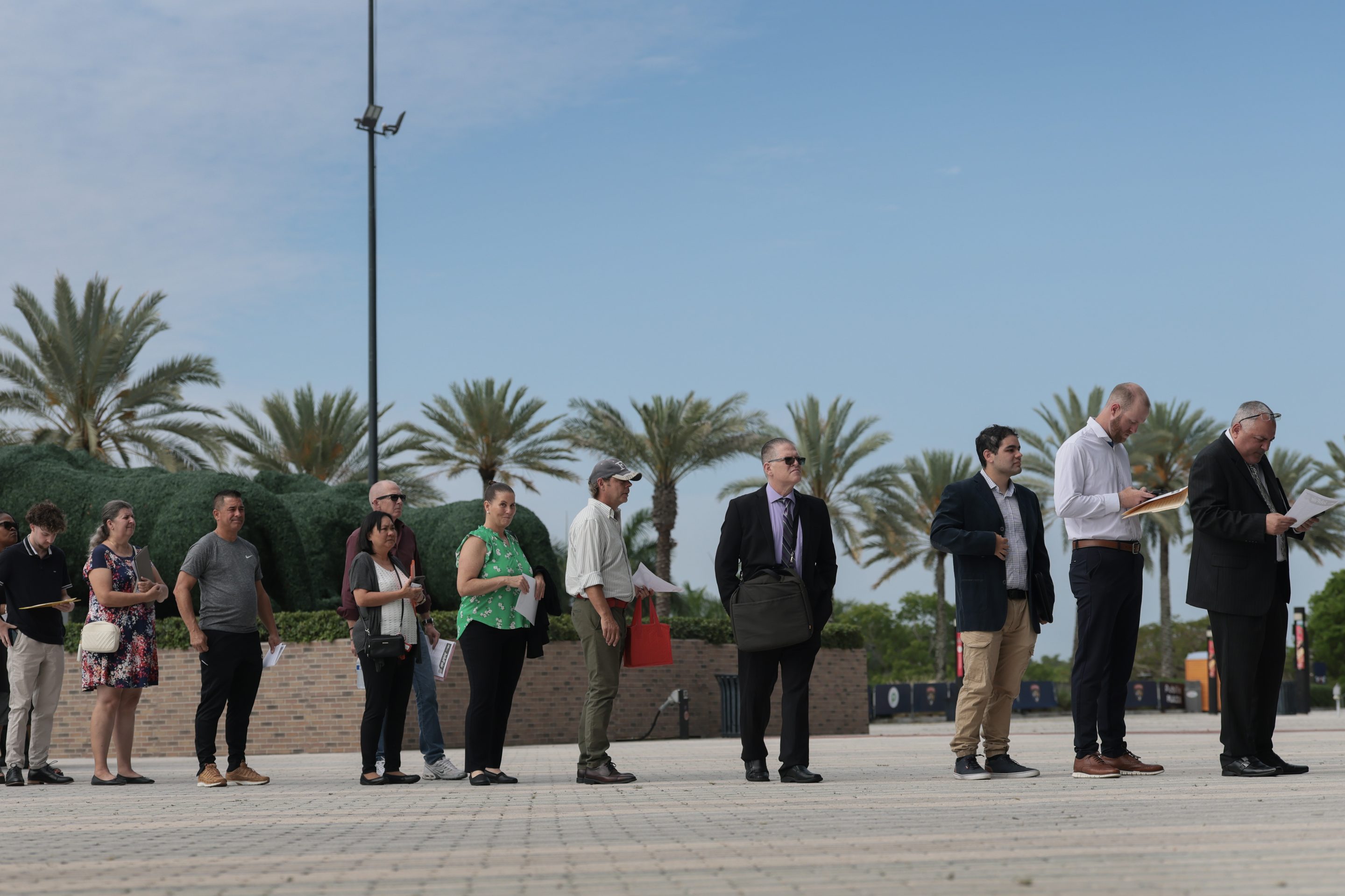 Job seekers wait in line to enter the Mega JobNewsUSA South Florida Job Fair held in the Amerant Bank Arena on April 30, 2026 in Sunrise, Florida.