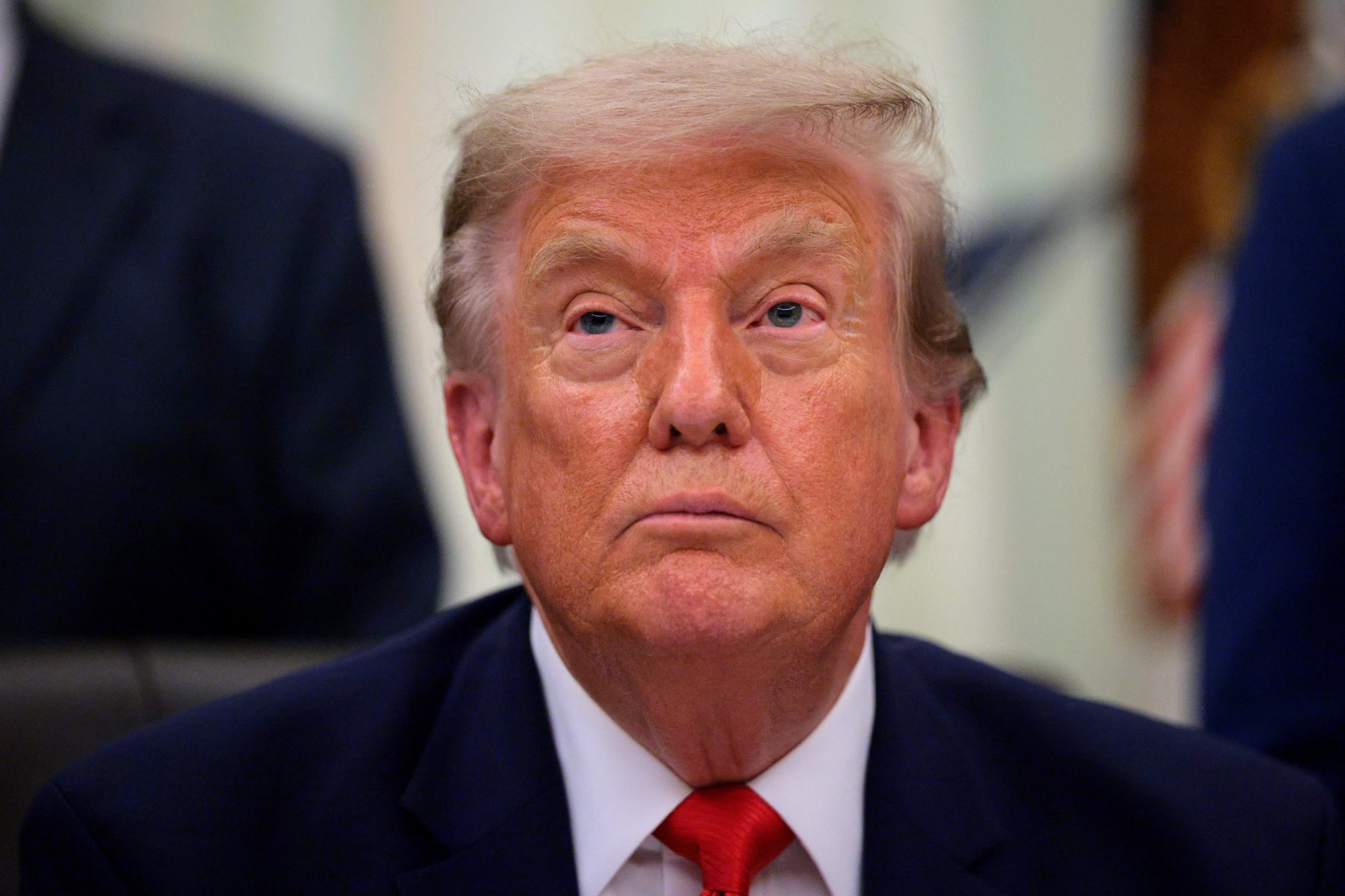 President Donald Trump looks on during an announcement.